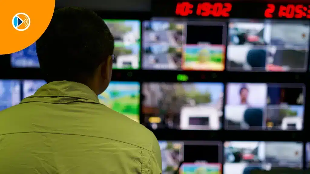 man-facing-the-large-tv-screens