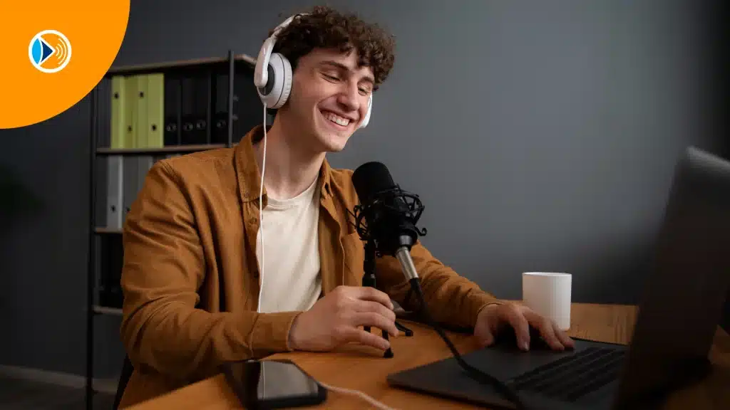 man-with-headset-smiling-infront-of the-tv-screen